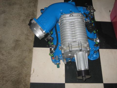 1996 Ford Thunderbird - A blue supercharger assembly with silver fins and a black pulley is shown.