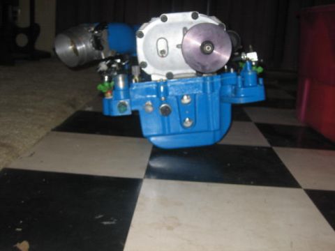 1996 Ford Thunderbird - A close-up view of a blue and silver automotive component with a purple disc is shown on a checkered floor.