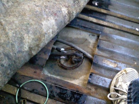 1990 Ford Bronco - A view of the vehicle's interior floor, showing a cut-out for access to the fuel pump assembly.