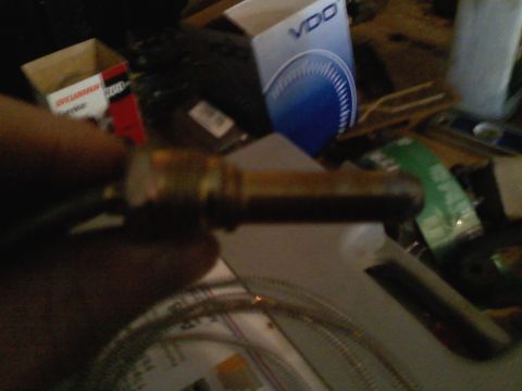 1990 Ford Bronco - Brass temperature sender with braided line, VDO gauge box in background.