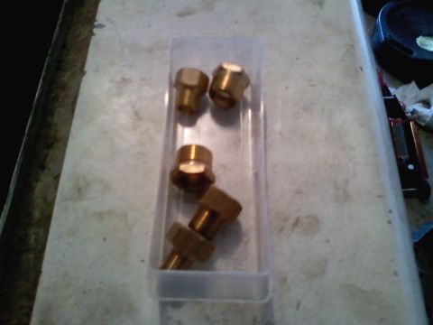 1990 Ford Bronco - A collection of brass fittings are neatly organized within a clear plastic container.