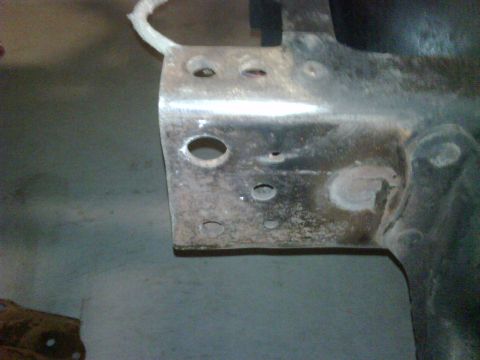 1979 Ford F-250 - Close-up of a metal bracket with various holes and signs of wear.
