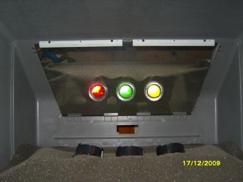 1989 Ford Bronco - The interior of a vehicle shows three illuminated indicator lights: red, green, and yellow.