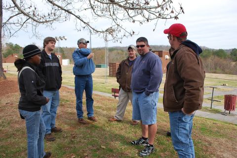 1979 Ford F-150 - A group of people stand together in an outdoor setting, possibly a park or recreational area.