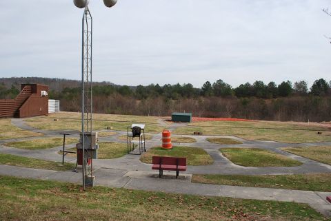 1979 Ford F-150 - A clay shooting range is set up with concrete paths and grass areas for participants.