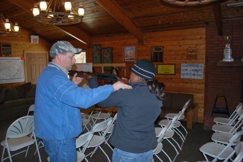 1979 Ford F-150 - Instructor guides a student on proper rifle technique in a classroom setting.