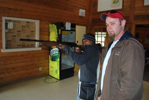 1979 Ford F-150 - Two men are inside a building, one is aiming a shotgun while the other looks on.