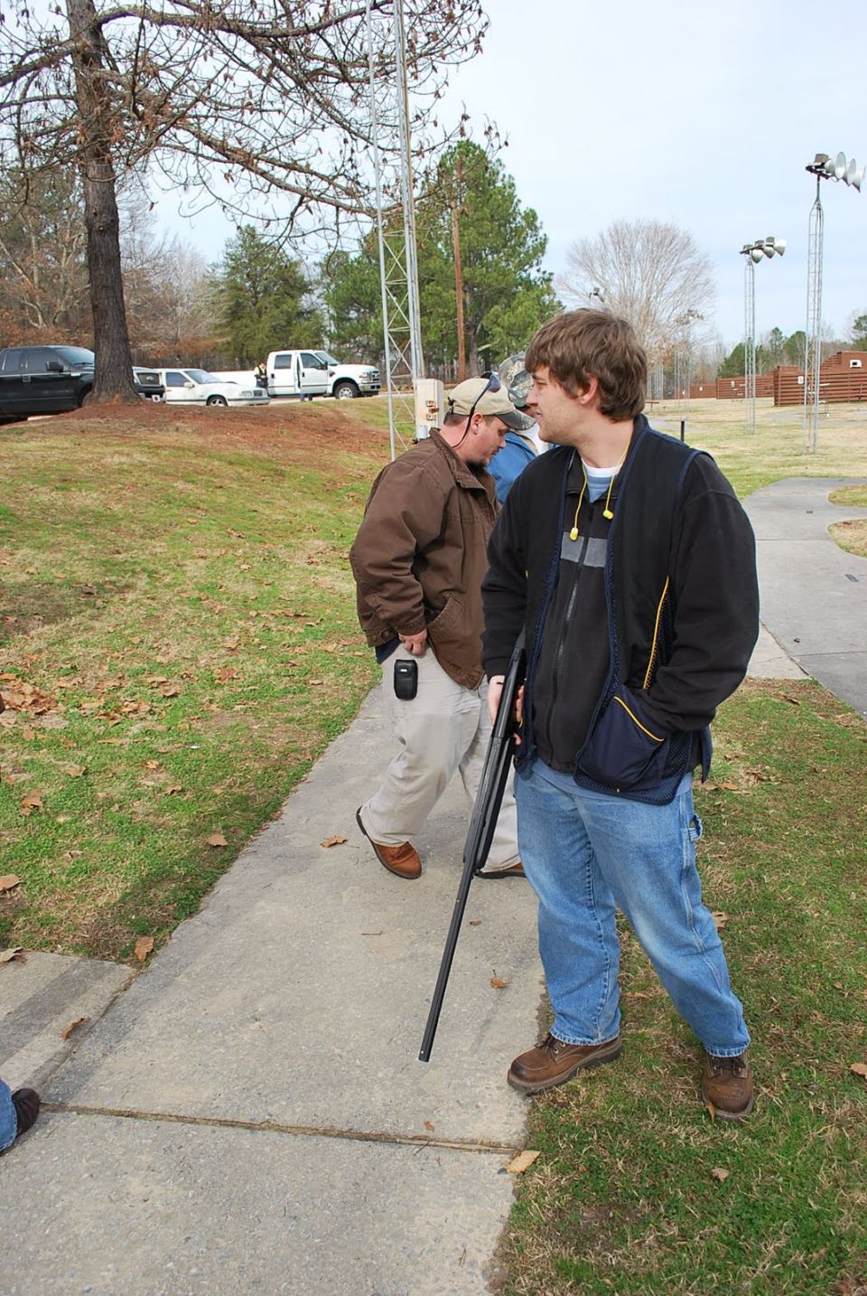People at a shooting range with a shotgun