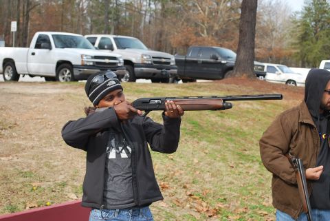 1979 Ford F-150 - Two people are holding shotguns outdoors, with several pickup trucks parked in the background.