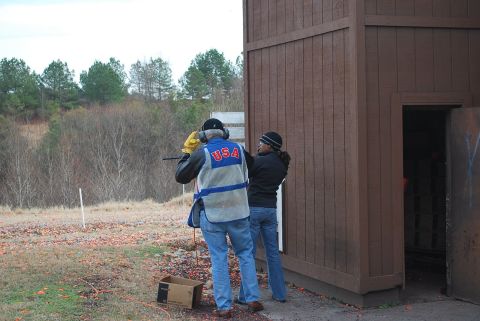 1979 Ford F-150 - A shooting instructor helps a student at an outdoor range.