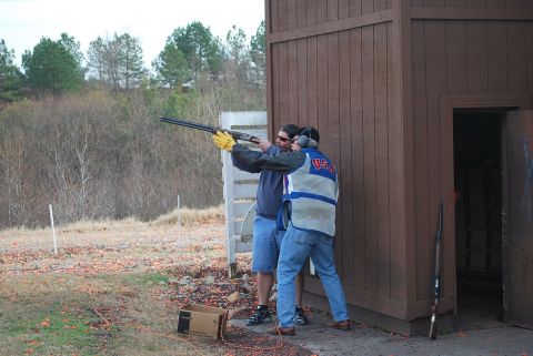 1979 Ford F-150 - Two men participate in a trap shooting event, with one preparing to fire a shotgun.