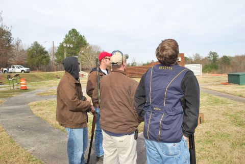 1979 Ford F-150 - A white pickup truck is visible in the background of a group of people at an outdoor range.