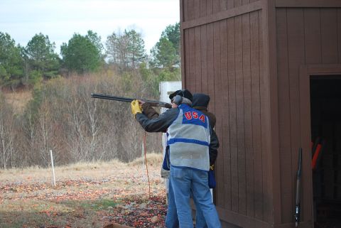 1979 Ford F-150 - A shooting competition with participants aiming shotguns at a clay pigeon range.