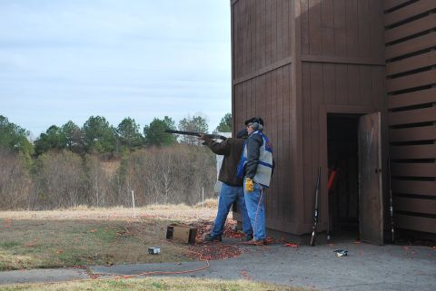 1979 Ford F-150 - Participants practice clay pigeon shooting at an outdoor range with a wooden shelter.