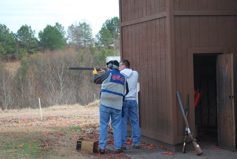 1979 Ford F-150 - A shooting range scene with two individuals participating in clay pigeon shooting.