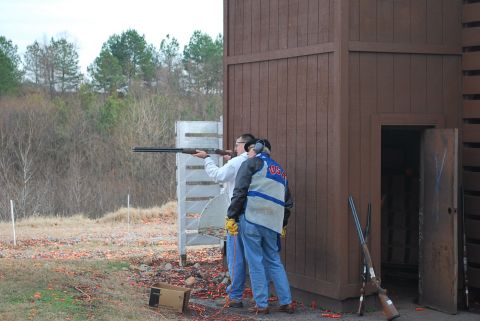 1979 Ford F-150 - A clay shooting event with participants and a wooden structure.