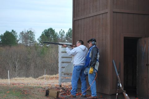 1979 Ford F-150 - Two men are at a shooting range, with one preparing to shoot a shotgun while the other observes.