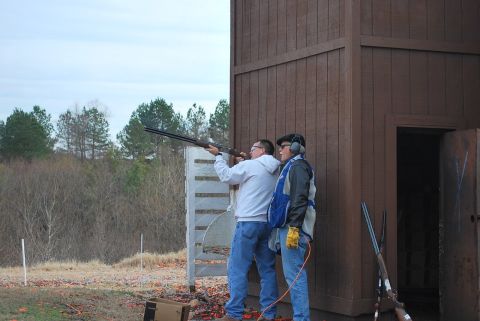 1979 Ford F-150 - Two men participate in a clay shooting event at an outdoor range.