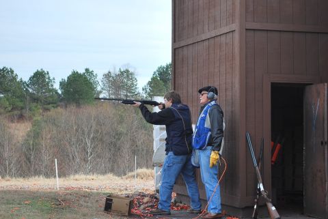 1979 Ford F-150 - A clay shooting event with participants practicing their aim at the range.
