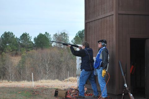 1979 Ford F-150 - Two individuals participate in clay pigeon shooting at an outdoor range.