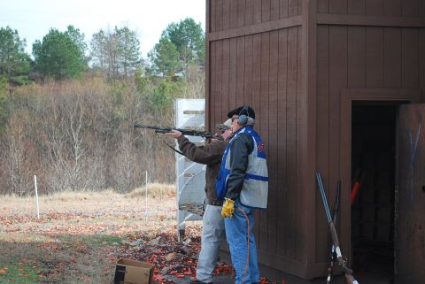 1979 Ford F-150 - Clay pigeon shooting event with participants aiming their shotguns at targets.