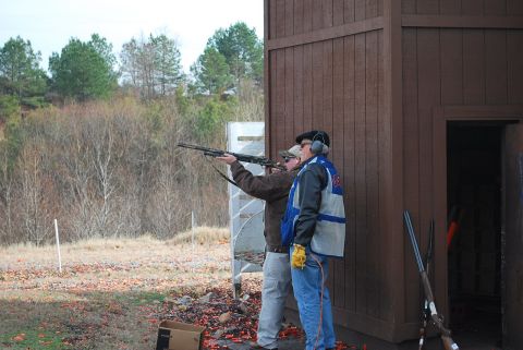 1979 Ford F-150 - Men practice shooting at a clay pigeon range, with shotgun shells scattered on the ground.