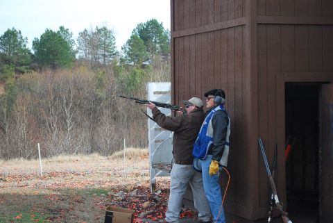 1979 Ford F-150 - Two men are at a shooting range, one aiming a shotgun while the other watches.