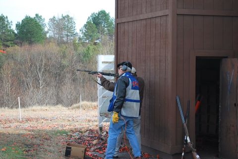 1979 Ford F-150 - Participants practice clay pigeon shooting at an outdoor range, with shotguns and spent shells visible.