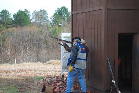 1979 Ford F-150 - Two individuals are engaged in shooting practice at an outdoor range, with clay targets visible on the ground.
