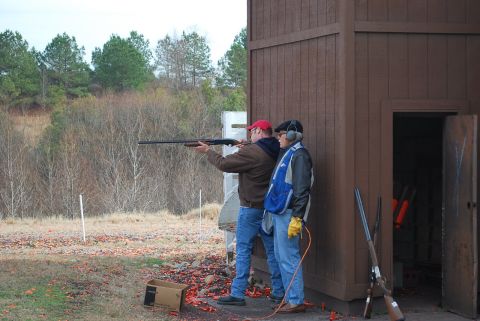 1979 Ford F-150 - Two men are at a shooting range, with one preparing to shoot a shotgun.
