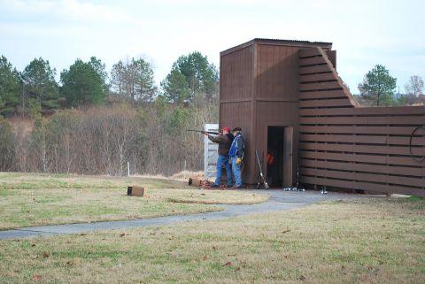 1979 Ford F-150 - Two men are at a shooting range, with one man taking aim at a clay pigeon.