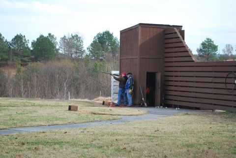 1979 Ford F-150 - Clay shooting range scene with two participants engaged in the sport.