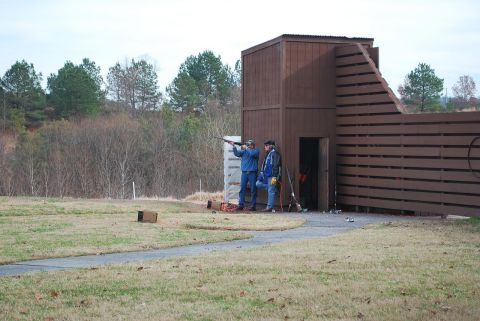 1979 Ford F-150 - A clay shooting range with two people participating in the sport.