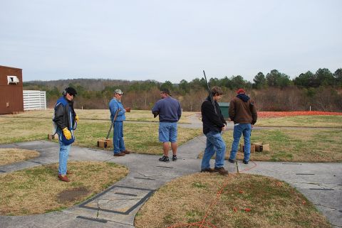 1979 Ford F-150 - A group of people are gathered at an outdoor shooting range on an overcast day.