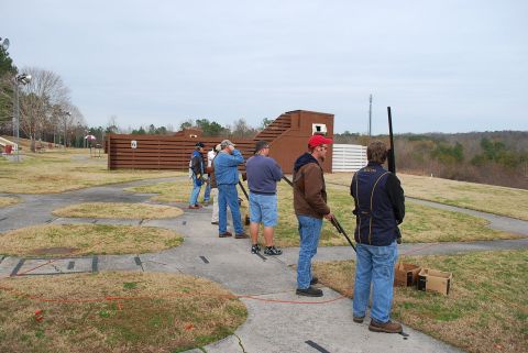1979 Ford F-150 - People gathered at an outdoor shooting range, preparing for clay pigeon shooting.
