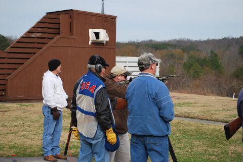 1979 Ford F-150 - Participants gather at an outdoor shooting range, with a wooden structure and trees visible.