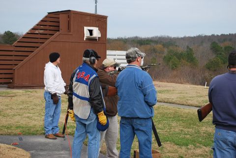 1979 Ford F-150 - Participants take aim at a shooting range during a company outing on a cloudy day.