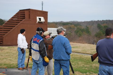 1979 Ford F-150 - Several individuals are engaged in shooting activities at an outdoor range.