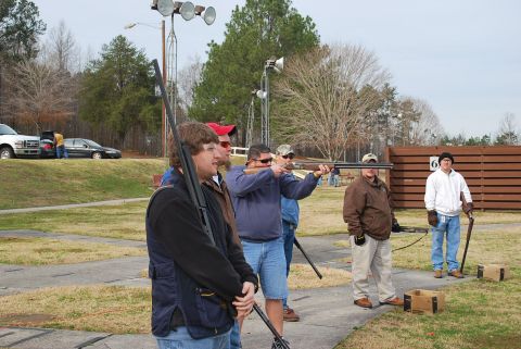 1979 Ford F-150 - A group of people are participating in a shooting event at an outdoor range.