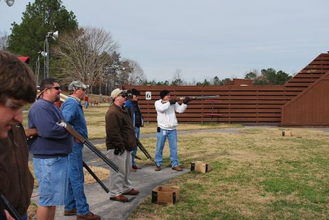 1979 Ford F-150 - A group of men are at a shooting range, with one person actively participating in the sport.
