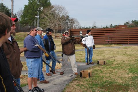 1979 Ford F-150 - Men gather at a shooting range, with one individual preparing to fire a shotgun.