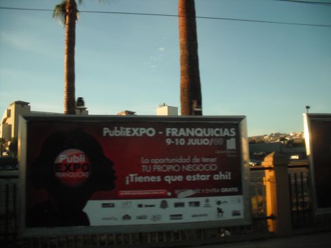 1991 Ford Bronco - Photo of an outdoor advertising billboard for a franchise expo, not a classifiable technical document.