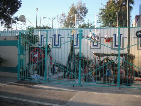 1991 Ford Bronco - A turquoise gate guards a yard decorated for Christmas with a nativity scene and festive ornaments.