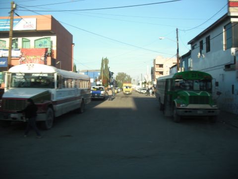 1991 Ford Bronco - A street scene with multiple buses and buildings under a clear blue sky.
