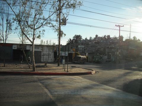 1991 Ford Bronco - A street corner in a populated area with several vehicles visible.