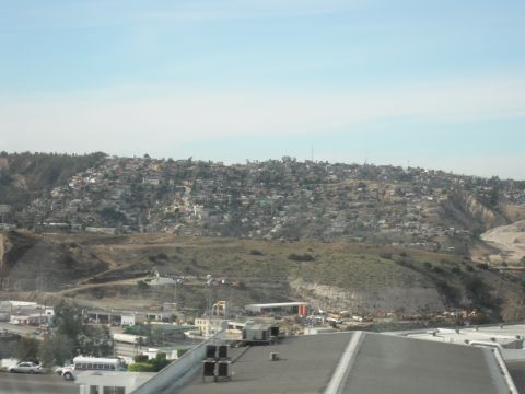 1991 Ford Bronco - A wide shot captures a densely populated hillside community under a clear blue sky, with a town and construction visible in the foreground.