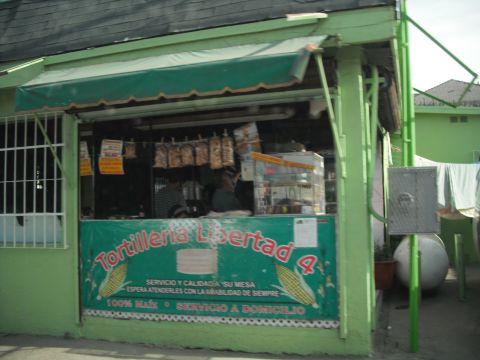 1991 Ford Bronco - A food stand with a green awning and a banner advertising 'Tortilleria Libertad 4' is visible.