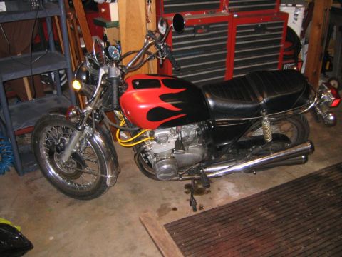 2002 Buell Lightning w/Fairing - A motorcycle with a flame-painted fuel tank is parked indoors.