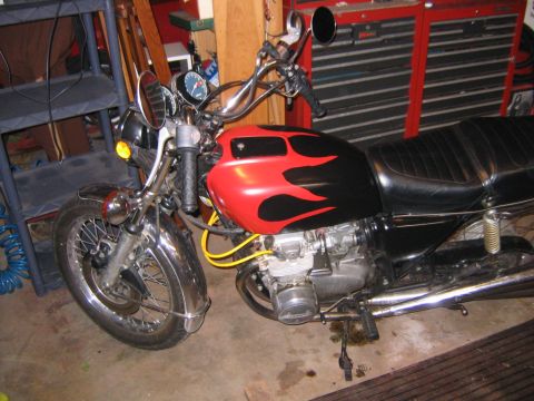 2002 Buell Lightning w/Fairing - Motorcycle fuel tank features red and black flame decals, chrome fender, and dual gauges.