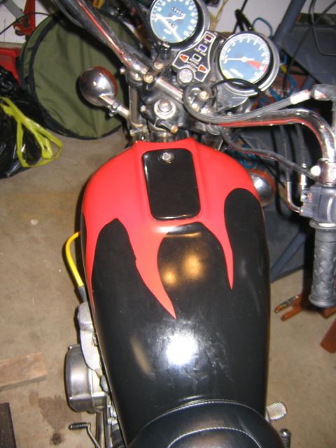 2002 Buell Lightning w/Fairing - Close-up of a motorcycle's fuel tank and handlebars, flame decals and dual gauges.